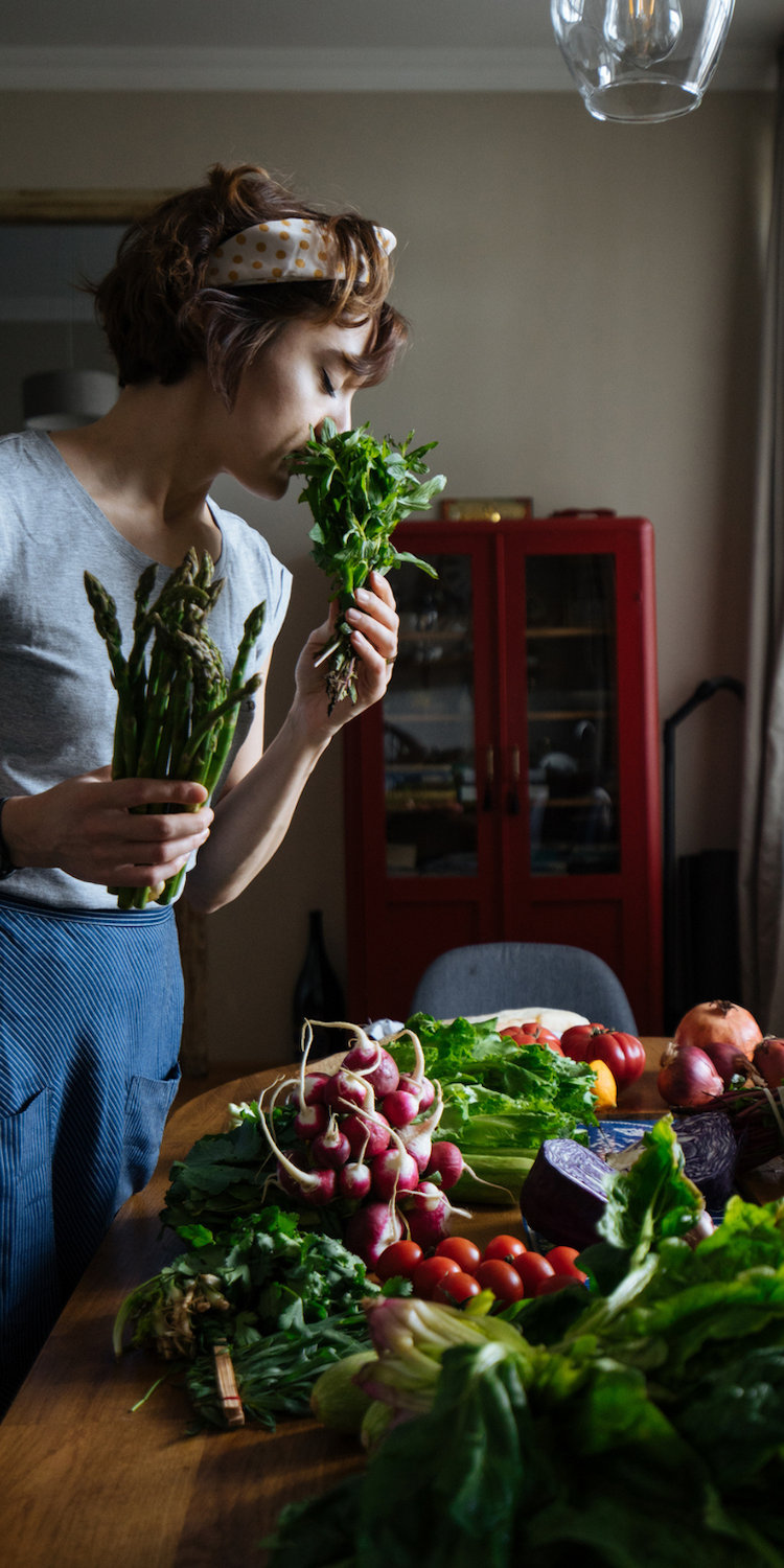Kobieta wąchająca warzywa